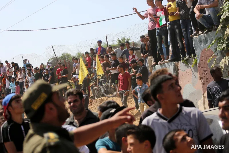 Palestinians gather at the Erez border crossing as Palestinian Prime Minister Rami Hamdallah's convoy arrives in the northern Gaza Strip on October 2, 2017. Hamdallah is on on his first visit to the Gaza Strip for talks...