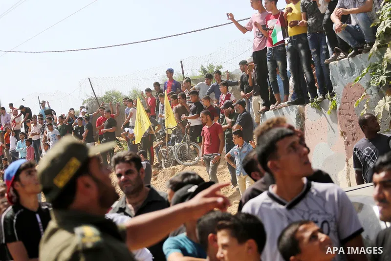 Palestinians gather at the Erez border crossing as Palestinian Prime Minister Rami Hamdallah's convoy arrives in the northern Gaza Strip on October 2, 2017. Hamdallah is on on his first visit to the Gaza Strip for talks...