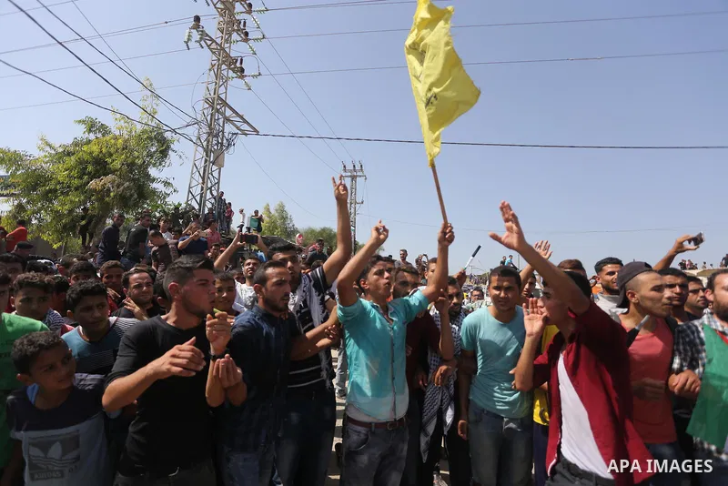 Palestinians celebrate at the Erez border crossing as Palestinian Prime Minister Rami Hamdallah's convoy arrives in the northern Gaza Strip on October 2, 2017. Hamdallah is on on his first visit to the Gaza Strip for tal...