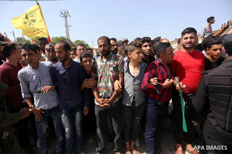 Palestinians celebrate at the Erez border crossing as Palestinian Prime Minister Rami Hamdallah's convoy arrives in the northern Gaza Strip on October 2, 2017. Hamdallah is on on his first visit to the Gaza Strip for tal...