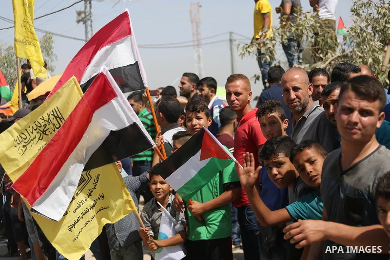 Palestinians celebrate at the Erez border crossing as Palestinian Prime Minister Rami Hamdallah's convoy arrives in the northern Gaza Strip on October 2, 2017. Hamdallah is on on his first visit to the Gaza Strip for tal...
