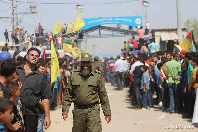 Palestinians celebrate at the Erez border crossing as Palestinian Prime Minister Rami Hamdallah's convoy arrives in the northern Gaza Strip on October 2, 2017. Hamdallah is on on his first visit to the Gaza Strip for tal...