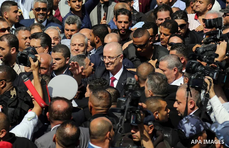Palestinian Prime Minister Rami Hamdallah is surrounded by security following his arrival at the Erez border crossing in the northern Gaza Strip on October 2, 2017. Hamdallah is on on his first visit to the Gaza Strip fo...