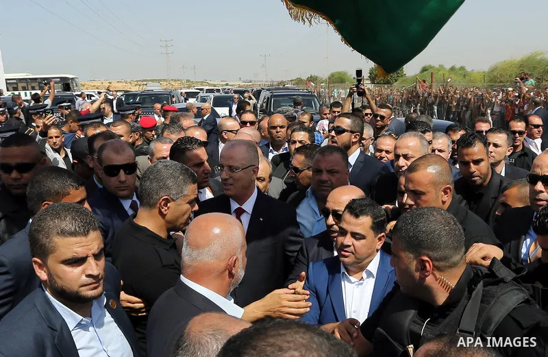 Palestinian Prime Minister Rami Hamdallah is surrounded by security following his arrival at the Erez border crossing in the northern Gaza Strip on October 2, 2017. Hamdallah is on on his first visit to the Gaza Strip fo...
