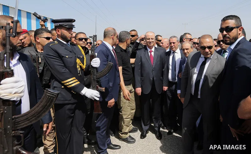 Palestinian Prime Minister Rami Hamdallah is surrounded by security following his arrival at the Erez border crossing in the northern Gaza Strip on October 2, 2017. Hamdallah is on on his first visit to the Gaza Strip fo...