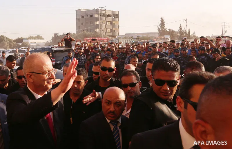 Palestinian Prime Minister Rami Hamdallah waves during his visit to the Shejaiya neighborhood in Gaza City on October 2, 2017. Palestinian prime minister Rami Hamdallah arrived in Gaza for his first visit in two years, s...