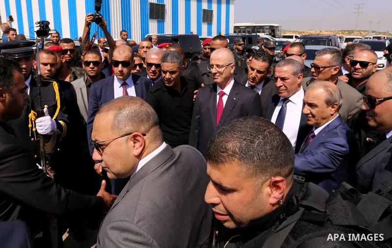 Palestinian Prime Minister Rami Hamdallah is surrounded by security following his arrival at the Erez border crossing in the northern Gaza Strip on October 2, 2017. Palestinian prime minister Rami Hamdallah arrived in Ga...
