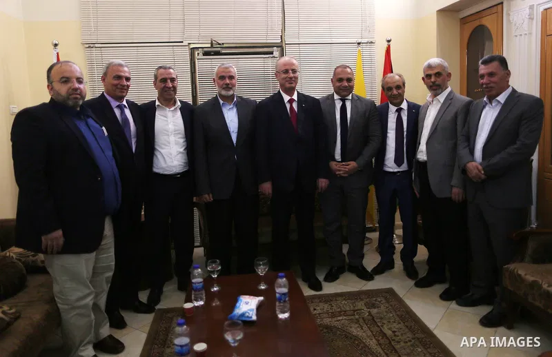 Hamas' overall leader Ismail Haniya, Palestinian prime minister Rami Hamdallah, Hamas's leader in the Gaza Strip Yahya Sinwar and Palestinian officials pose for a photo following a meeting in Gaza City October 2, 2017. P...