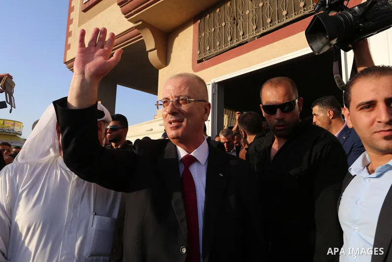Palestinian Prime Minister Rami Hamdallah waves during his visit to the Shejaiya neighborhood in Gaza City on October 2, 2017. Palestinian prime minister Rami Hamdallah arrived in Gaza for his first visit in two years, s...