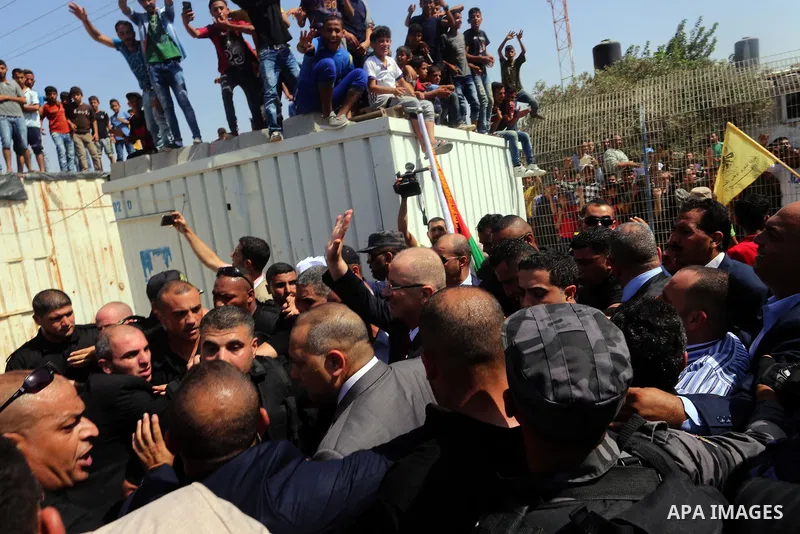 Palestinian Prime Minister Rami Hamdallah is surrounded by security following his arrival at the Erez border crossing in the northern Gaza Strip on October 2, 2017. Palestinian prime minister Rami Hamdallah arrived in Ga...