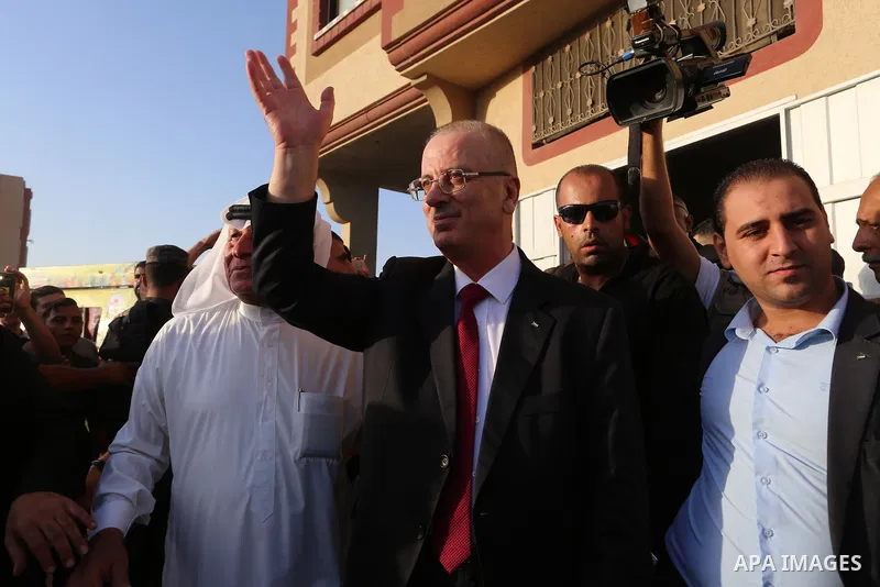 Palestinian Prime Minister Rami Hamdallah waves during his visit to the Shejaiya neighborhood in Gaza City on October 2, 2017. Palestinian prime minister Rami Hamdallah arrived in Gaza for his first visit in two years, s...