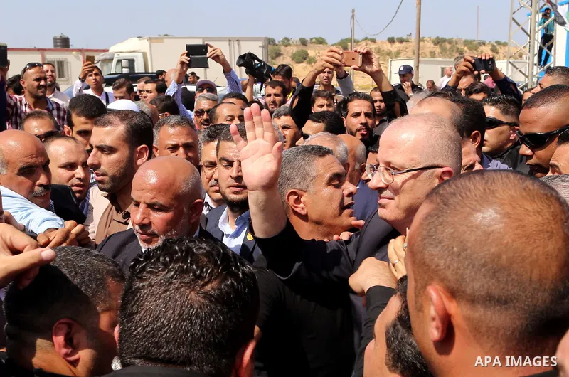 Palestinian Prime Minister Rami Hamdallah is surrounded by security following his arrival at the Erez border crossing in the northern Gaza Strip on October 2, 2017. Palestinian prime minister Rami Hamdallah arrived in Ga...