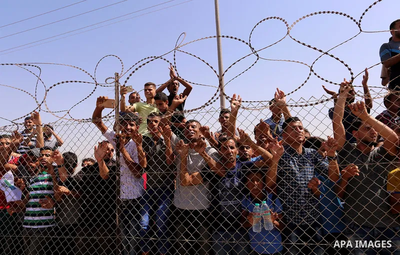Palestinians celebrate at the Erez border crossing as Palestinian Prime Minister Rami Hamdallah's convoy arrives in the northern Gaza Strip on October 2, 2017. Palestinian prime minister Rami Hamdallah arrived in Gaza fo...