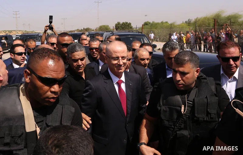 Palestinian Prime Minister Rami Hamdallah is surrounded by security following his arrival at the Erez border crossing in the northern Gaza Strip on October 2, 2017. Palestinian prime minister Rami Hamdallah arrived in Ga...