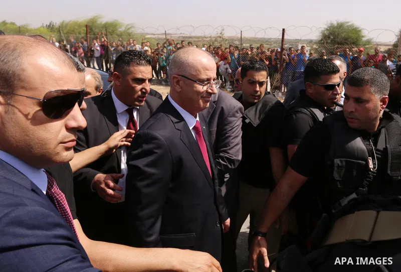 Palestinian Prime Minister Rami Hamdallah is surrounded by security following his arrival at the Erez border crossing in the northern Gaza Strip on October 2, 2017. Palestinian prime minister Rami Hamdallah arrived in Ga...