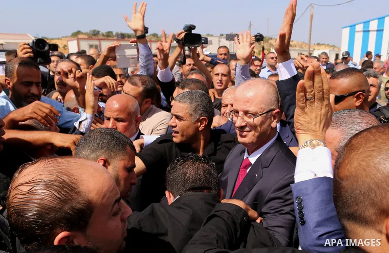 Palestinian Prime Minister Rami Hamdallah is surrounded by security following his arrival at the Erez border crossing in the northern Gaza Strip on October 2, 2017. Palestinian prime minister Rami Hamdallah arrived in Ga...