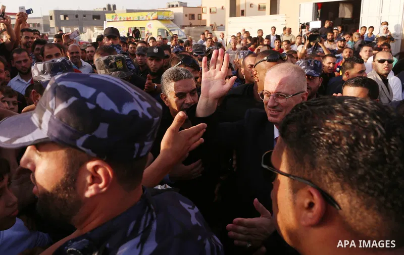 Palestinian Prime Minister Rami Hamdallah waves during his visit to the Shejaiya neighborhood in Gaza City on October 2, 2017. Palestinian prime minister Rami Hamdallah arrived in Gaza for his first visit in two years, s...