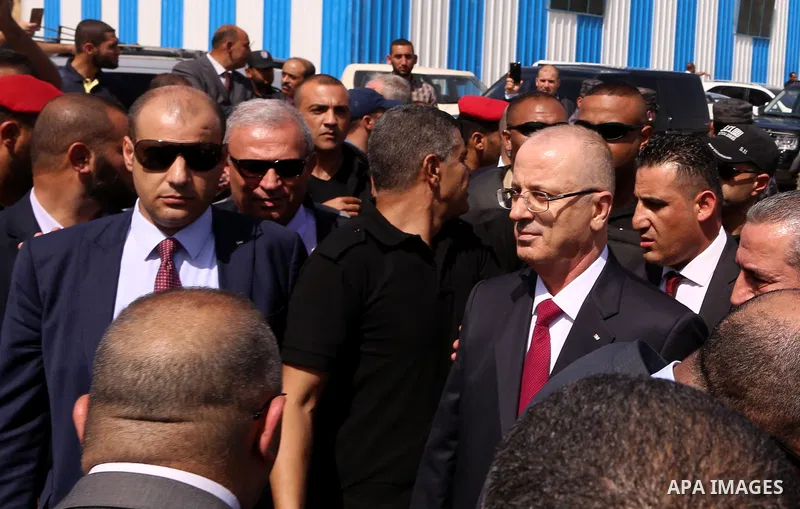Palestinian Prime Minister Rami Hamdallah is surrounded by security following his arrival at the Erez border crossing in the northern Gaza Strip on October 2, 2017. Palestinian prime minister Rami Hamdallah arrived in Ga...