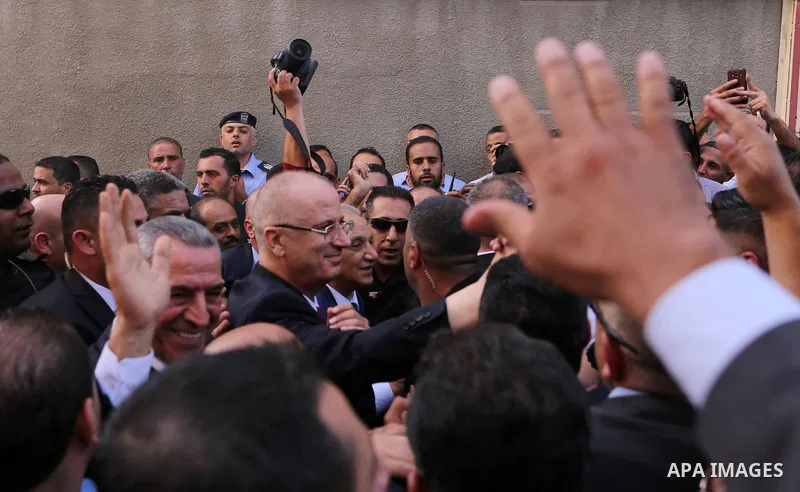 Palestinian Prime Minister Rami Hamdallah waves during his visit to the Shejaiya neighborhood in Gaza City on October 2, 2017. Palestinian prime minister Rami Hamdallah arrived in Gaza for his first visit in two years, s...