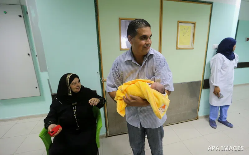 A Palestinian father, Saher Abdel Basset, holds his newly born baby, Rami Hamdallah, named at al-shifaa hospital, in Gaza city on October 2, 2017. Palestinian prime minister Rami Hamdallah arrived in Gaza for his first v...