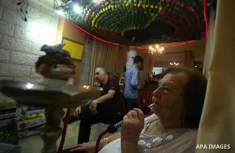 A member of the Samaritan sect decorates a traditional hut known as a sukkot with fruits and vegetables on Mount Gerizim, on the outskirts of the West Bank city of Nablus, October 2, 2017. A sukkot is a ritual hut used d...
