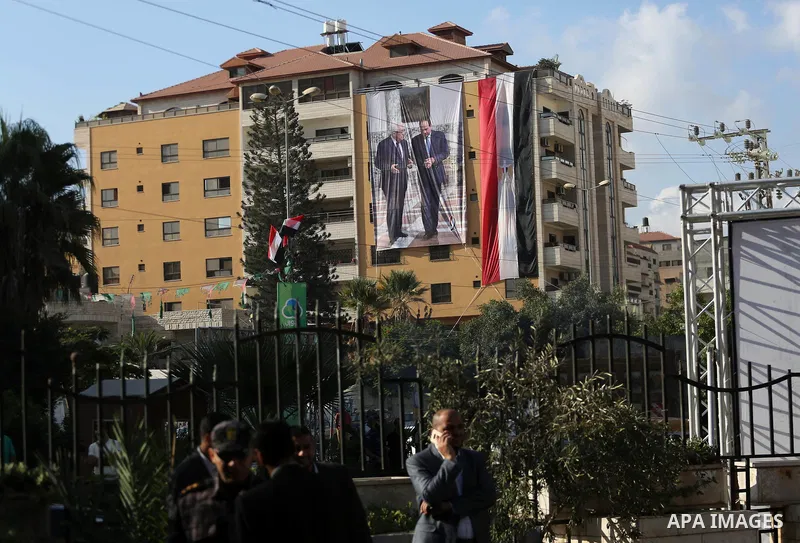 Palestinian security forces in Gaza strip stand guard as an Egyptian flag with a big poster of Palestinian President Mahmoud Abbas and Egyptian President Abdel Fattah Al-Sisi hang from a building near the Palestinian gov...