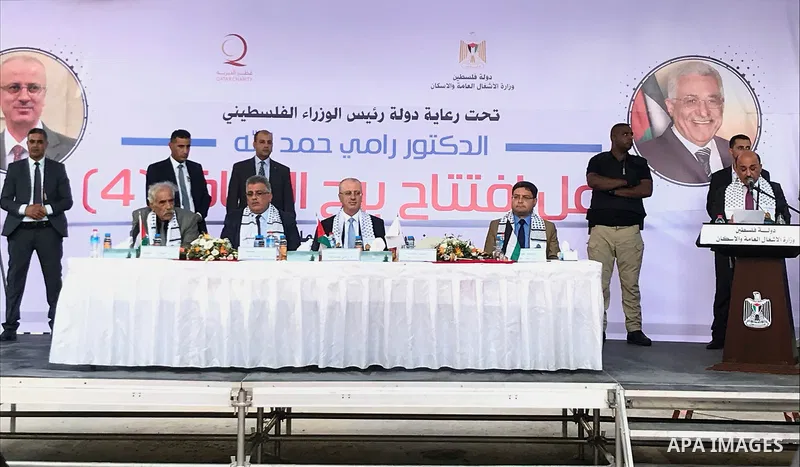 Palestinian Prime Minister Rami Hamdallah attends the opening ceremony of al-Zafer building, which was destroyed during the recent Israeli war on Gaza Strip, in Gaza city on October 3, 2017. Photo by Alaa Sarraj
