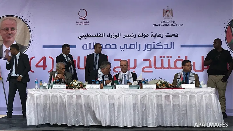 Palestinian Prime Minister Rami Hamdallah attends the opening ceremony of al-Zafer building, which was destroyed during the recent Israeli war on Gaza Strip, in Gaza city on October 3, 2017. Photo by Alaa Sarraj