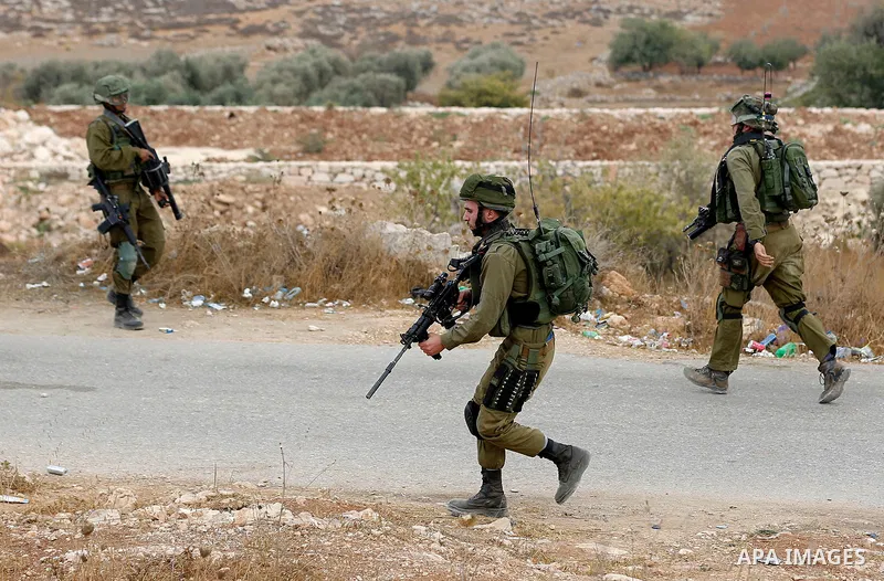 Israeli security forces take position during a protest by Palestinians demanding the reopening of the main road to the Qalqas village that was closed by Israel almost 17 years ago in the West Bank city of Hebron October...