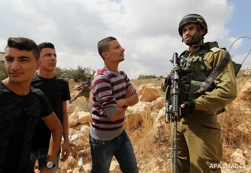 Palestinian protesters argue with Israeli security forces during a protest demanding the reopening of the main road to the Qalqas village that was closed by Israel almost 17 years ago in the West Bank city of Hebron Octo...