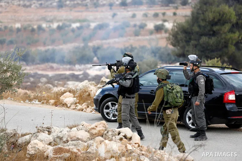 Israeli security forces take position during a protest by Palestinians demanding the reopening of the main road to the Qalqas village that was closed by Israel almost 17 years ago in the West Bank city of Hebron October...