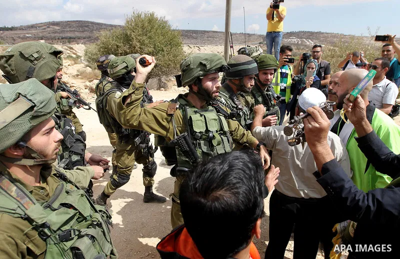 Palestinian protesters argue with Israeli security forces during a protest demanding the reopening of the main road to the Qalqas village that was closed by Israel almost 17 years ago in the West Bank city of Hebron Octo...