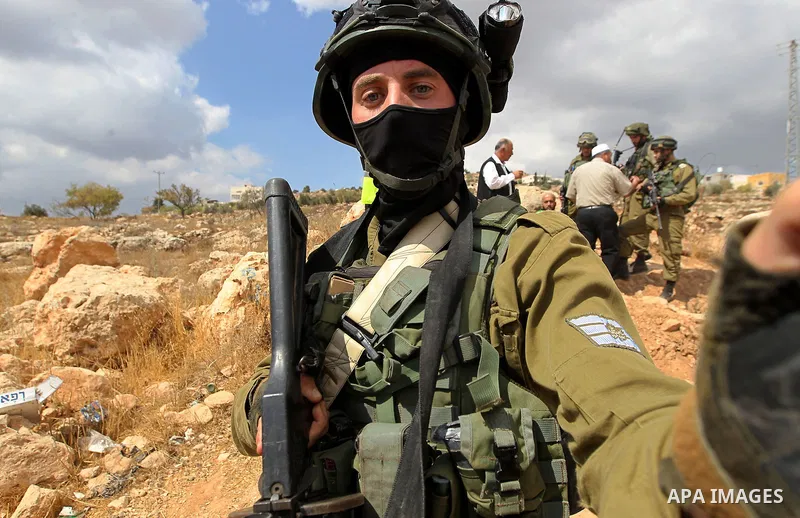 Israeli security forces take position during a protest by Palestinians demanding the reopening of the main road to the Qalqas village that was closed by Israel almost 17 years ago in the West Bank city of Hebron October...