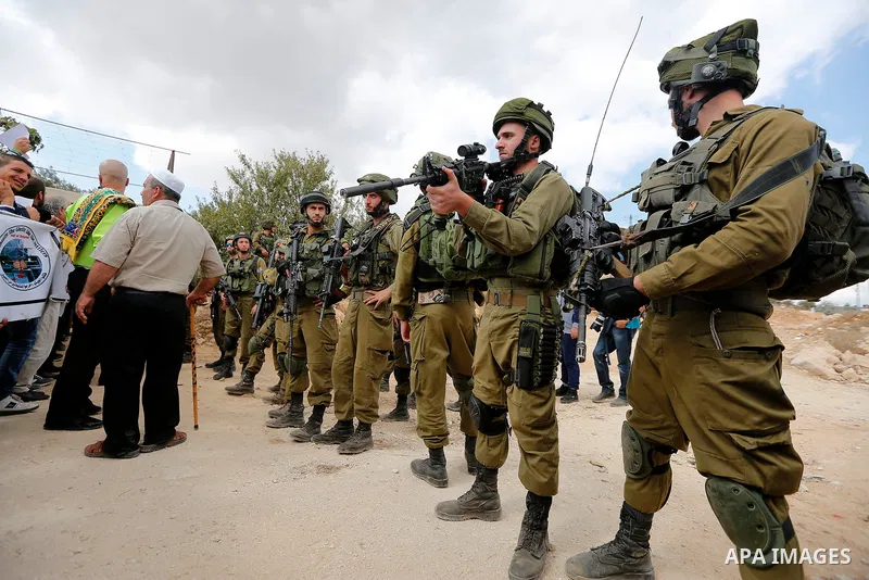 Palestinian protesters take part during a protest demanding the reopening of the main road to the Qalqas village that was closed by Israel almost 17 years ago in the West Bank city of Hebron October 6, 2017. Photo by Wis...