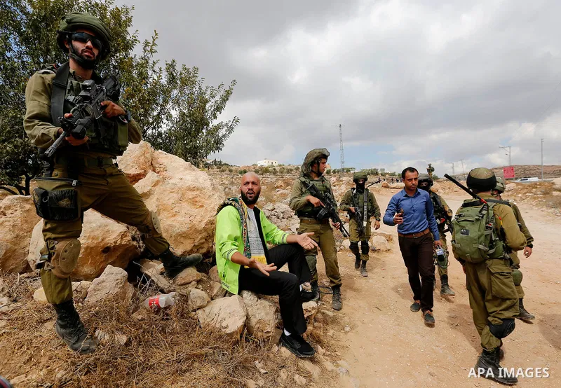 Palestinian protesters argue with Israeli security forces during a protest demanding the reopening of the main road to the Qalqas village that was closed by Israel almost 17 years ago in the West Bank city of Hebron Octo...
