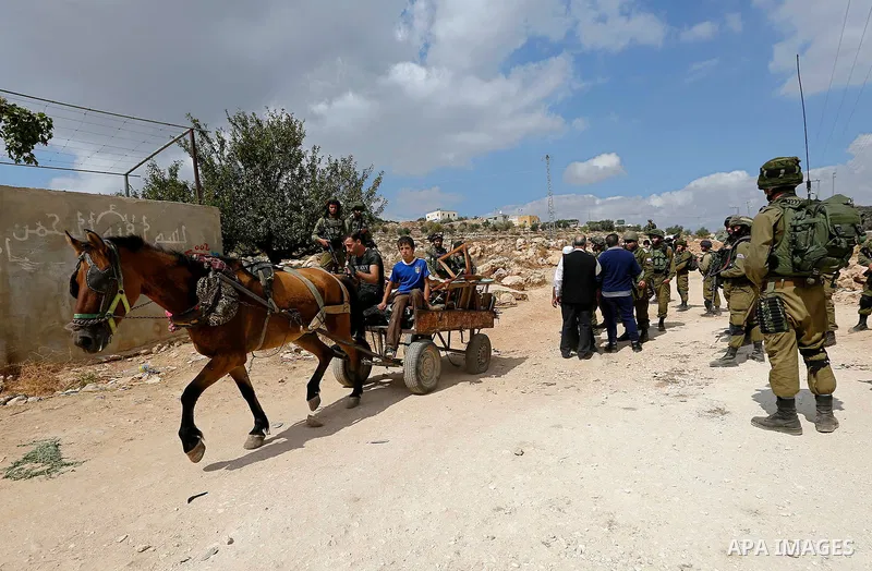 Palestinian protesters take part during a protest demanding the reopening of the main road to the Qalqas village that was closed by Israel almost 17 years ago in the West Bank city of Hebron October 6, 2017. Photo by Wis...