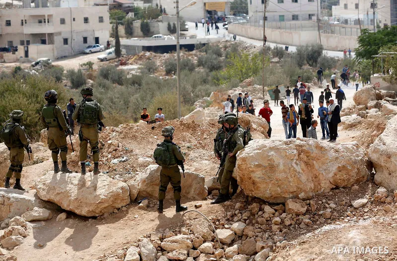 Israeli security forces take position during a protest by Palestinians demanding the reopening of the main road to the Qalqas village that was closed by Israel almost 17 years ago in the West Bank city of Hebron October...