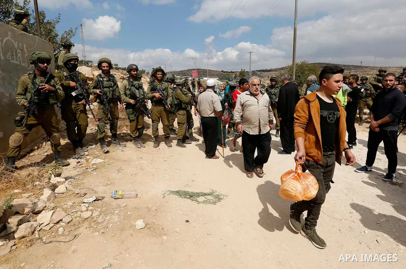 Palestinian protesters take part during a protest demanding the reopening of the main road to the Qalqas village that was closed by Israel almost 17 years ago in the West Bank city of Hebron October 6, 2017. Photo by Wis...