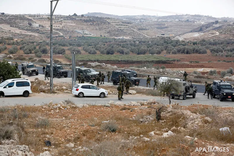 Palestinian protesters take part during a protest demanding the reopening of the main road to the Qalqas village that was closed by Israel almost 17 years ago in the West Bank city of Hebron October 6, 2017. Photo by Wis...