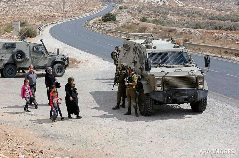Israeli security forces take position during a protest by Palestinians demanding the reopening of the main road to the Qalqas village that was closed by Israel almost 17 years ago in the West Bank city of Hebron October...