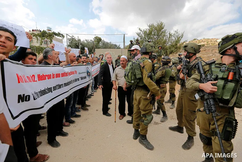Palestinian protesters take part during a protest demanding the reopening of the main road to the Qalqas village that was closed by Israel almost 17 years ago in the West Bank city of Hebron October 6, 2017. Photo by Wis...