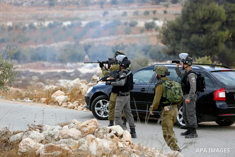 Israeli security forces take position during a protest by Palestinians demanding the reopening of the main road to the Qalqas village that was closed by Israel almost 17 years ago in the West Bank city of Hebron October...