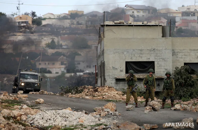 Israeli security forces take position during clashes with Palestinian protesters following a demonstration against the expropriation of Palestinian land by Israel in the village of Kfar Qaddum, near Nablus in the occupie...