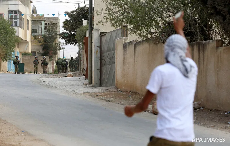 Israeli security forces take position during clashes with Palestinian protesters following a demonstration against the expropriation of Palestinian land by Israel in the village of Kfar Qaddum, near Nablus in the occupie...