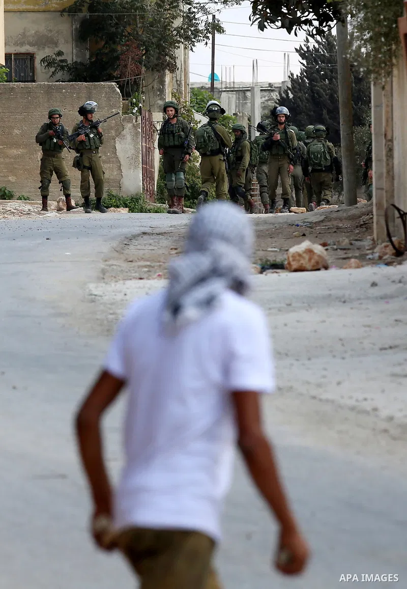 Israeli security forces take position during clashes with Palestinian protesters following a demonstration against the expropriation of Palestinian land by Israel in the village of Kfar Qaddum, near Nablus in the occupie...