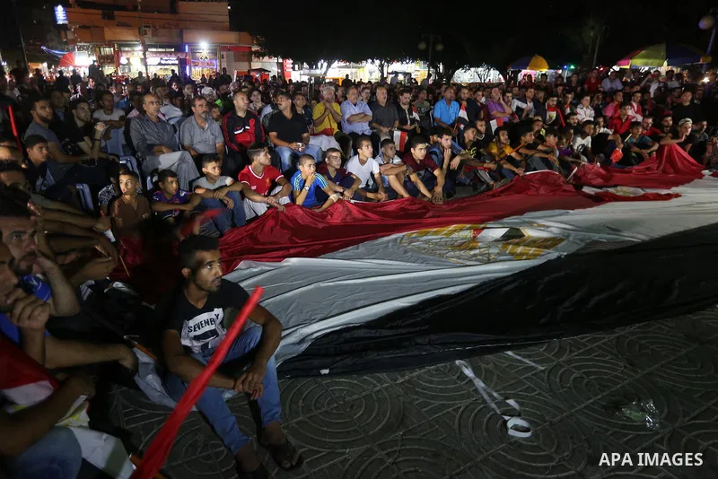 Palestinian fans watch the World Cup 2018 Africa qualifying football match between Egypt and Congo via large screens in Gaza City on October 8, 2017. Photo by Mohammed Asad