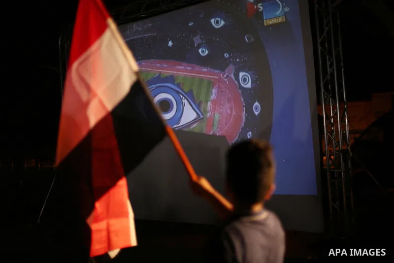 Palestinian fans watch the World Cup 2018 Africa qualifying football match between Egypt and Congo via large screens in Gaza City on October 8, 2017. Photo by Mohammed Asad