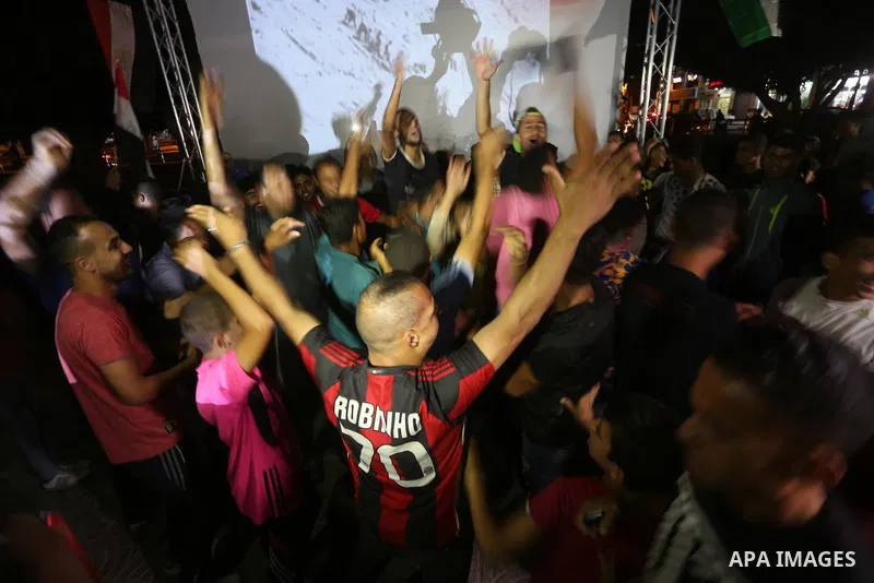 Palestinian fans watch the World Cup 2018 Africa qualifying football match between Egypt and Congo via large screens in Gaza City on October 8, 2017. Photo by Mohammed Asad