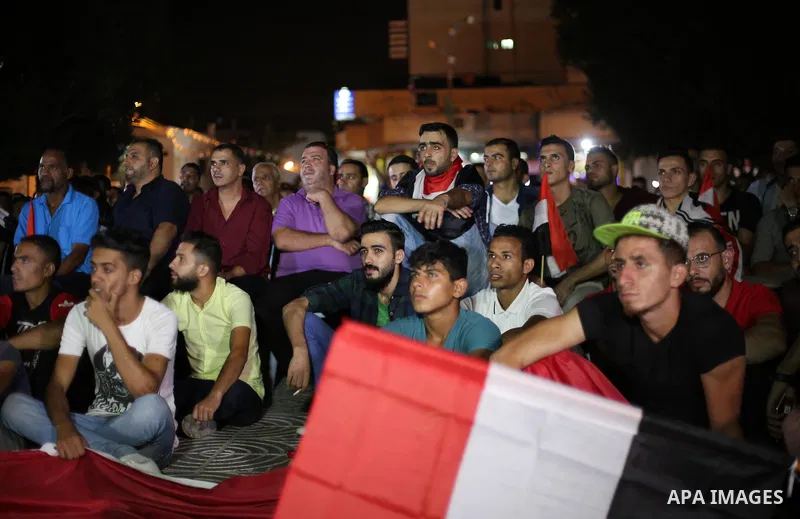 Palestinian fans watch the World Cup 2018 Africa qualifying football match between Egypt and Congo via large screens in Gaza City on October 8, 2017. Photo by Mohammed Asad