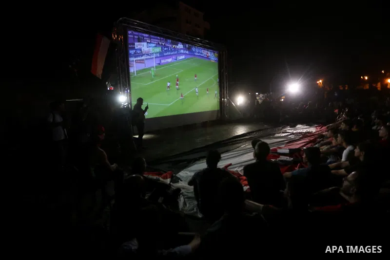 Palestinian fans watch the World Cup 2018 Africa qualifying football match between Egypt and Congo via large screens in Gaza City on October 8, 2017. Photo by Mohammed Asad